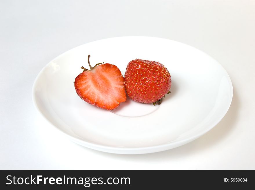 Ripe strawberries in a plate, isolated on white