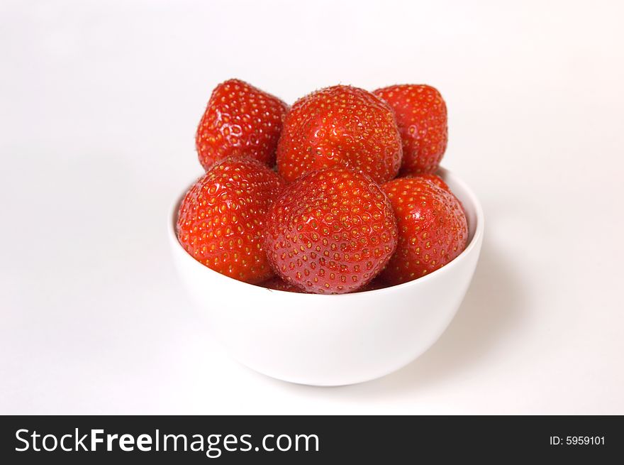 Fresh and tasty strawberries in a plate, isolated on white