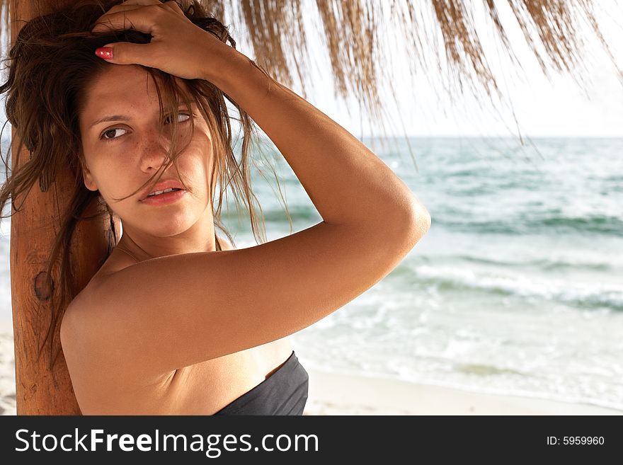 Young beautiful woman on beach near sea. Young beautiful woman on beach near sea
