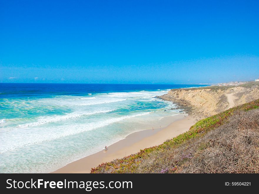 Beautiful Beach In Portugal With Cliff And Blue Sky