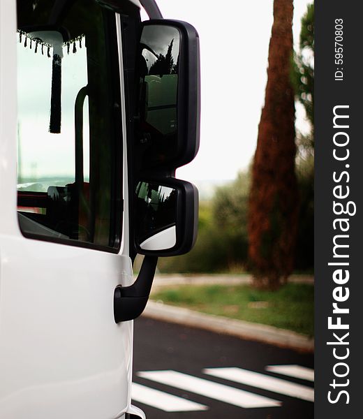 Door and window view of a white truck on vertical.Blur background. Door and window view of a white truck on vertical.Blur background.
