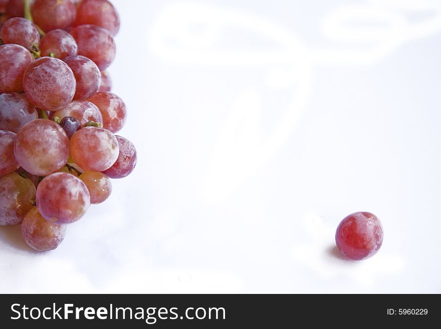 Bunch of grapes over a white background