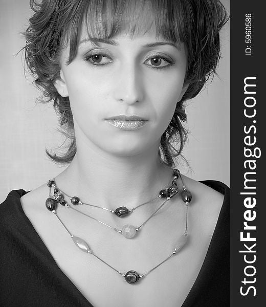 Beautiful girl with beads, black-and-white portrait