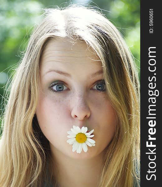 Expressive face of a model with flower in her mouth. Expressive face of a model with flower in her mouth