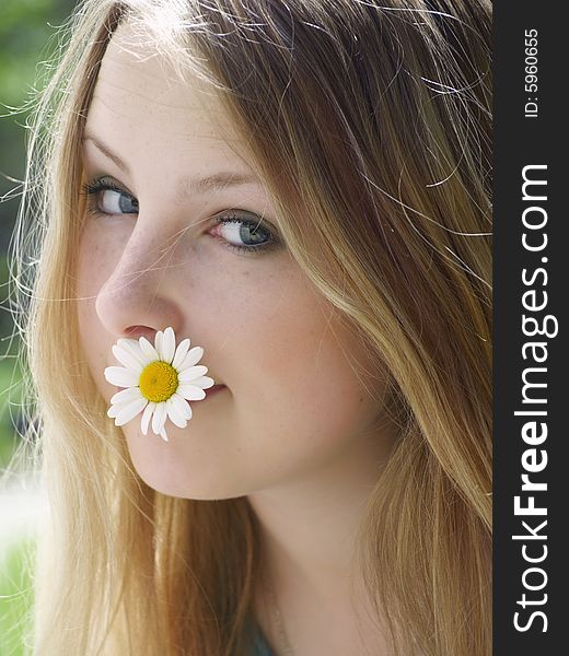 Expressive face of a model with flower in her mouth. Expressive face of a model with flower in her mouth