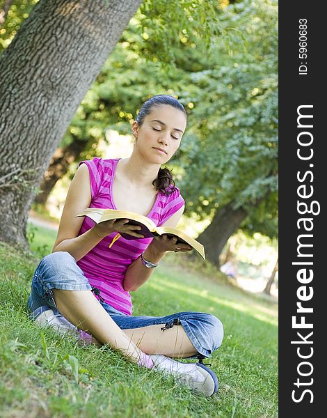 Young woman praying in park