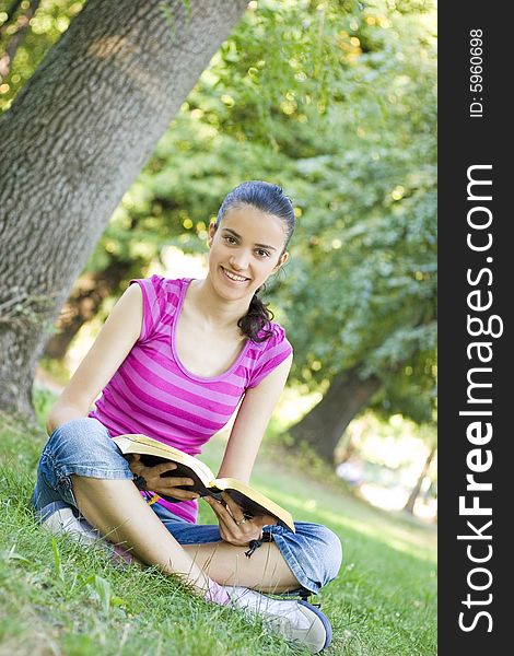 Young woman praying in park