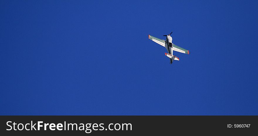 A plane doing acrobatic figures in the sky. A plane doing acrobatic figures in the sky.