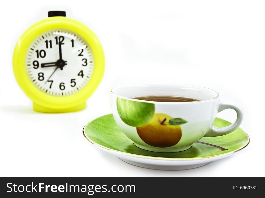 Hours and a cup on a white background. Hours and a cup on a white background