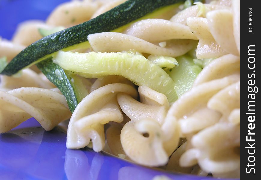 Close up of italian  integral pasta with zucchinis .Shallow DOF