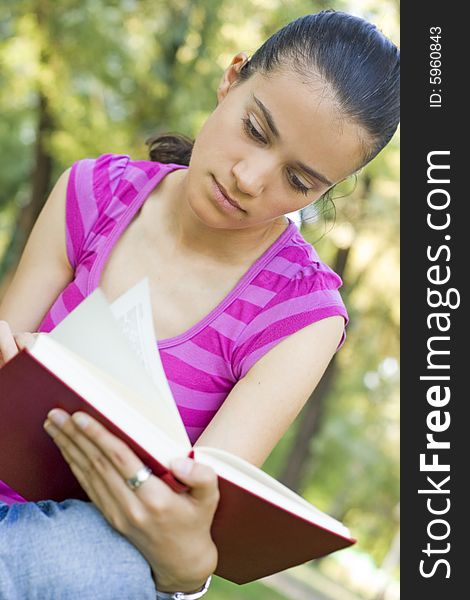 young woman reading book outdoor. young woman reading book outdoor