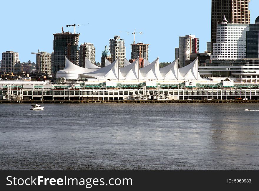 Vancouver cruise liner terminal water in foreground against blue sky. room for text. Vancouver cruise liner terminal water in foreground against blue sky. room for text