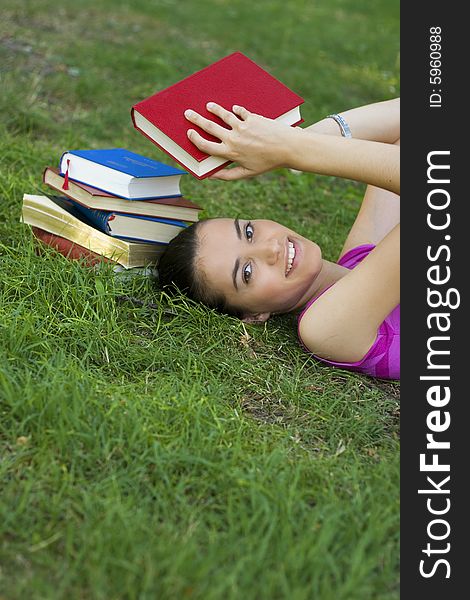Young woman reading book outdoor. Young woman reading book outdoor