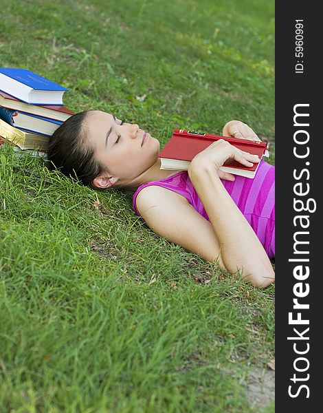 Young woman reading book outdoor. Young woman reading book outdoor