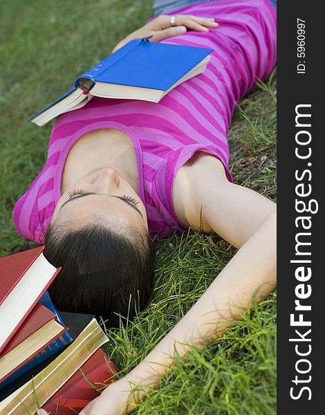 Young woman reading book outdoor. Young woman reading book outdoor