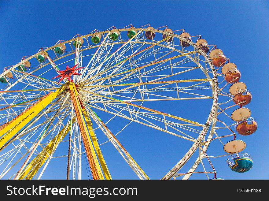 Observation wheel under blue sky