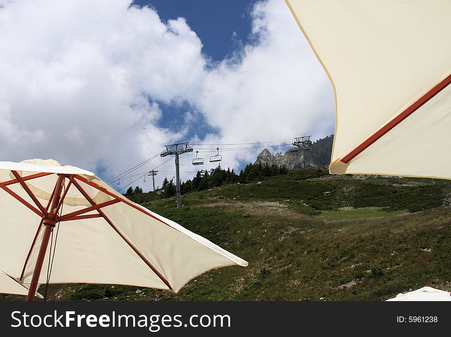 Viewing the ski lift from the shade of the parasols at the cafe. Viewing the ski lift from the shade of the parasols at the cafe