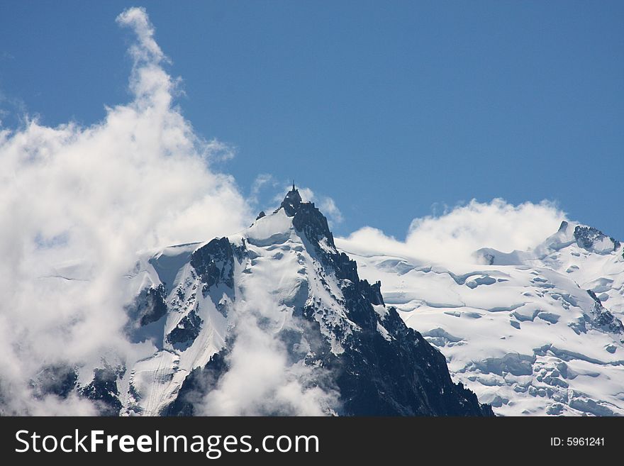 Clouds and snowfields on a peak of the Mont Blanc range. Clouds and snowfields on a peak of the Mont Blanc range