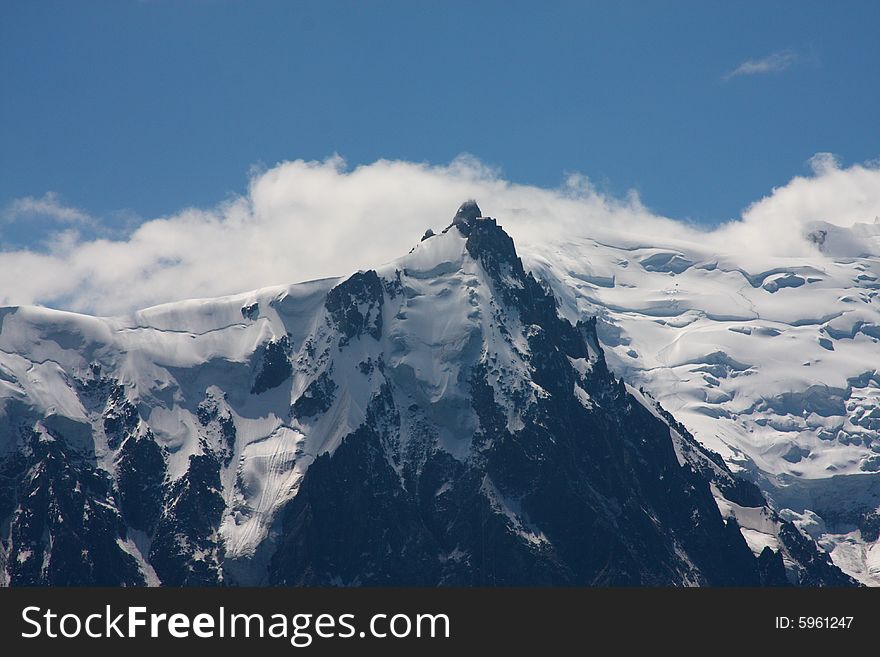 Clouds and snowfields on a peak of the Mont Blanc range. Clouds and snowfields on a peak of the Mont Blanc range