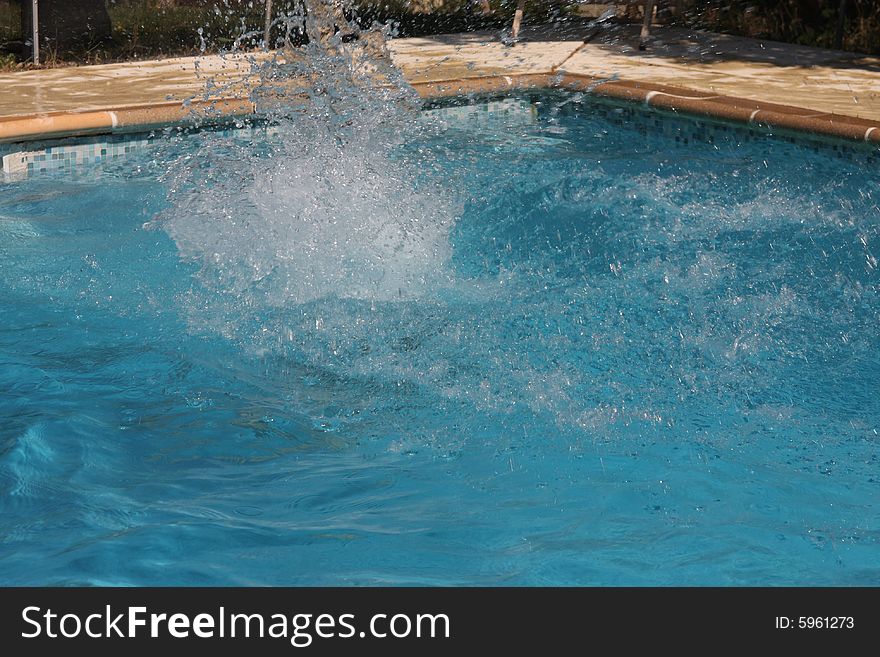 Person diving into a swimming pool. Person diving into a swimming pool
