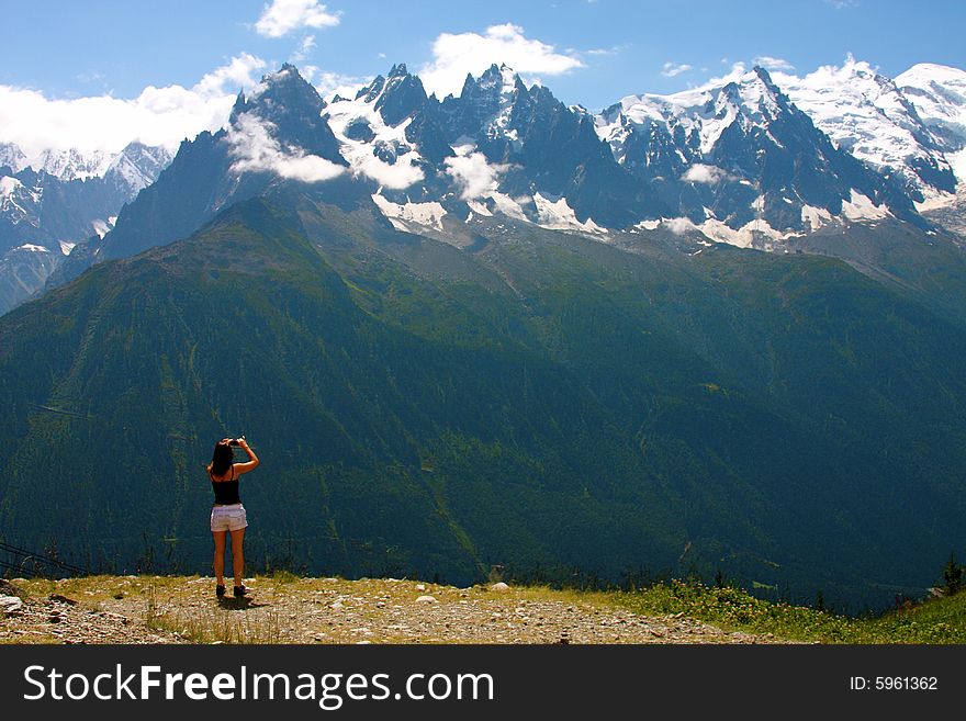 Woman looking across the valley at the Mont Blanc range. Woman looking across the valley at the Mont Blanc range