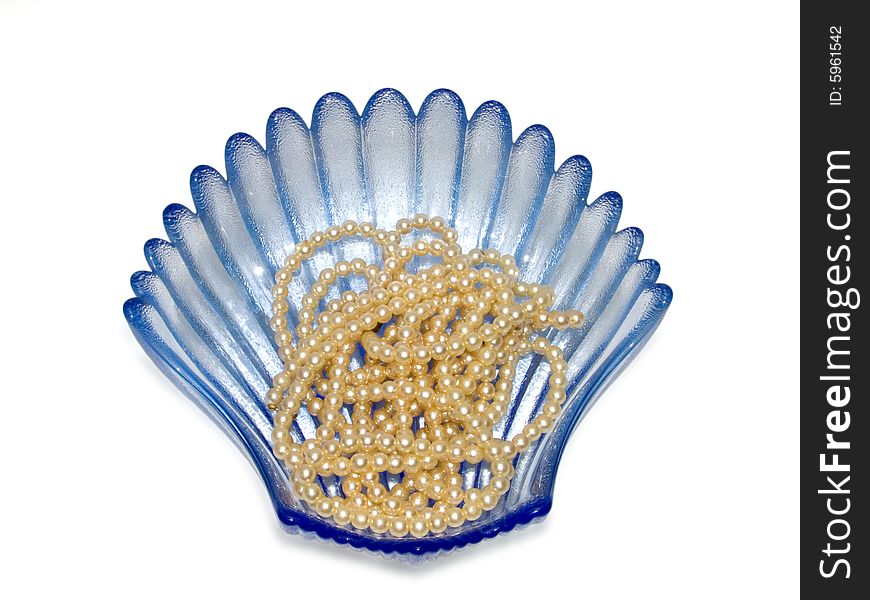 Blue vase and pearls on a white background