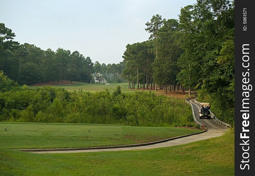 A golf cart rides over the wooden bridge connecting holes on a Myrtle Beach Golf course in South Carolina. A golf cart rides over the wooden bridge connecting holes on a Myrtle Beach Golf course in South Carolina.