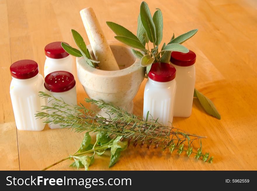 Herbs , spice jars and mortar , pestle. Herbs , spice jars and mortar , pestle