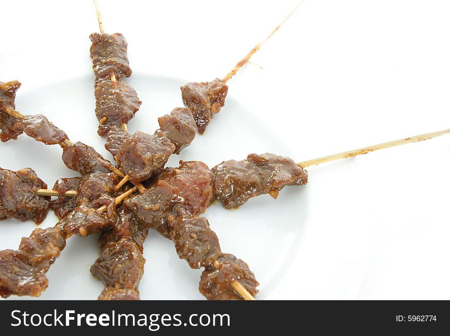 Satay or sate, dice-sized meat on bamboo skewers