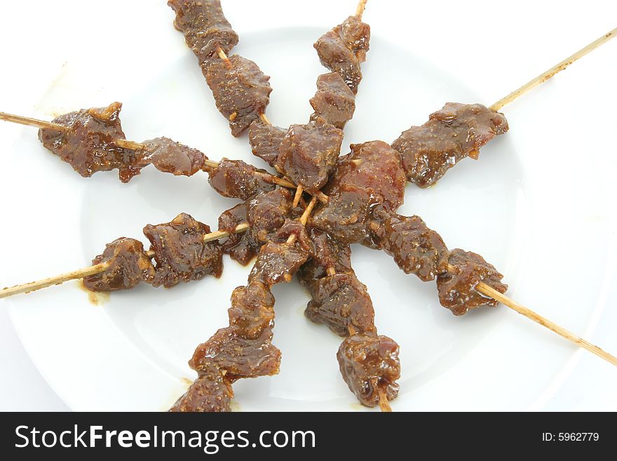 Satay or sate, dice-sized meat on bamboo skewers