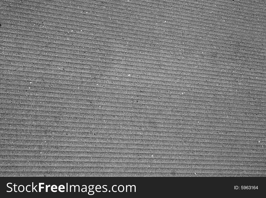 Grayscale picture of a concrete pavement with a wavy pattern. Grayscale picture of a concrete pavement with a wavy pattern