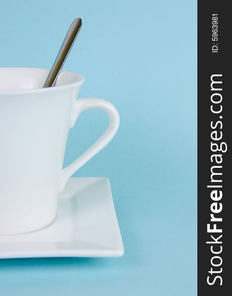 A cup of black coffee isolated against a blue background