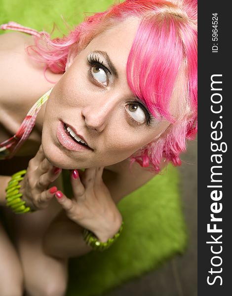 Closeup of Pretty Woman with Pink Hair on Green Rug