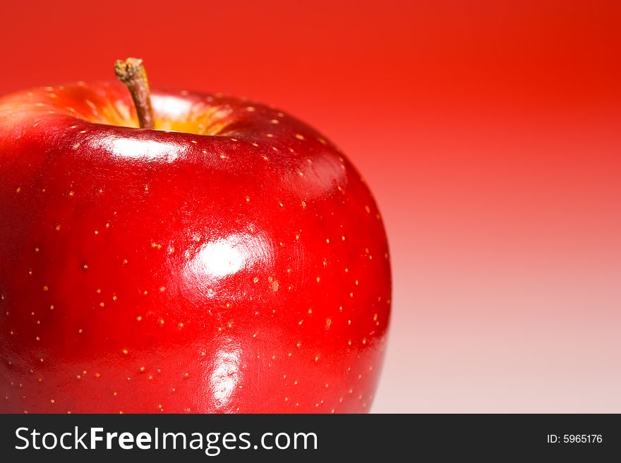 Red Shinny Apple on a red gradient background. Red Shinny Apple on a red gradient background