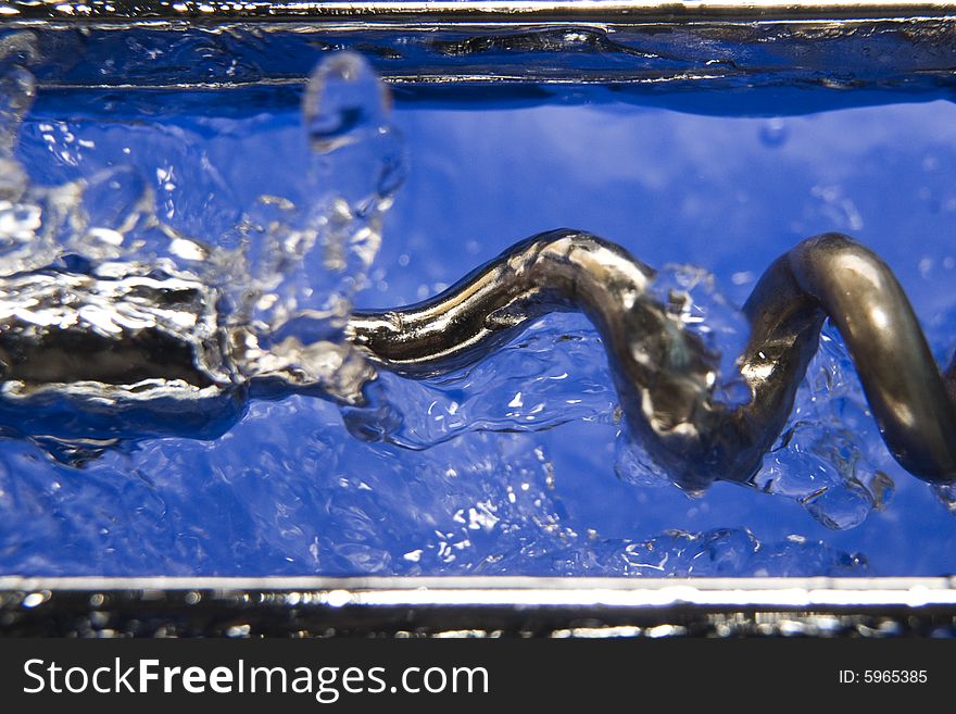 Metal corkscrew on the liquid water drops. Metal corkscrew on the liquid water drops