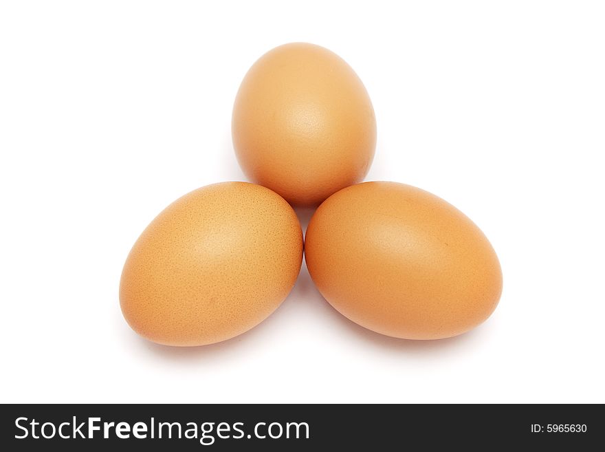 Three eggs aligned in triangle pattern on white background.