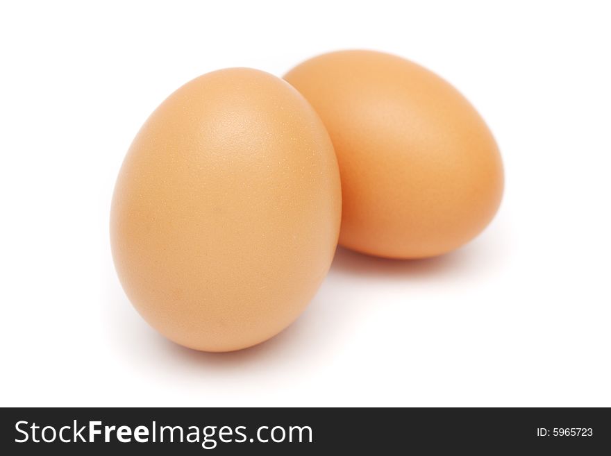 Close up of two eggs on white background.