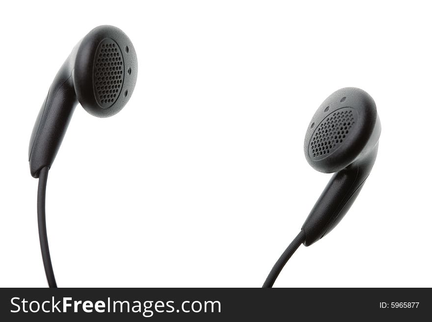 Closeup of a pair of small black headphones isolated against white background with copyspace in centre