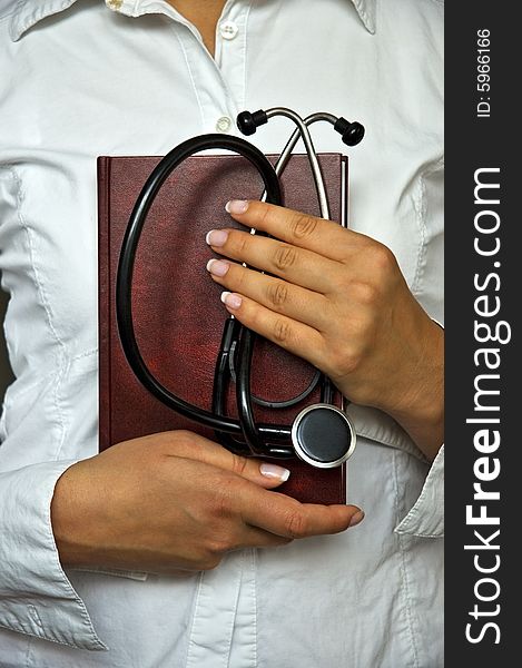 Young female doctor have stethoscope and notebook