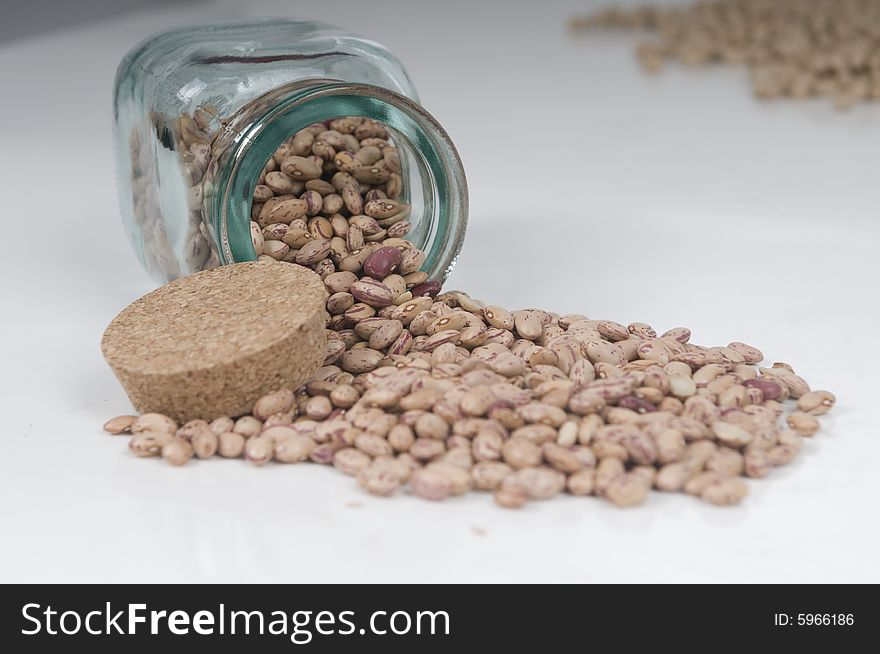 Half Filled Transparent Jar Of Red Haricot