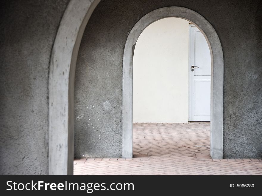 Mysterious Door Seen Through Arches