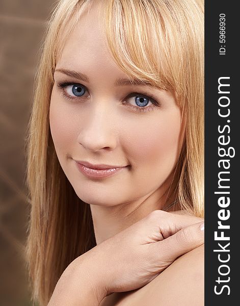 Portrait of a beautiful blonde woman with light blue eyes and natural make-up. Portrait of a beautiful blonde woman with light blue eyes and natural make-up