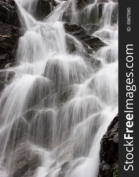 River flowing down upon the mountain rocks. River flowing down upon the mountain rocks