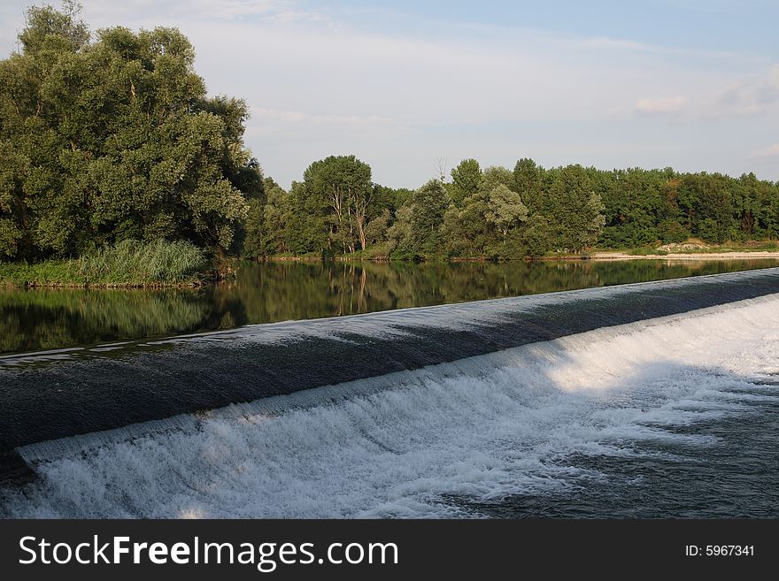 A small river Adda's waterfall in a summer day. A small river Adda's waterfall in a summer day