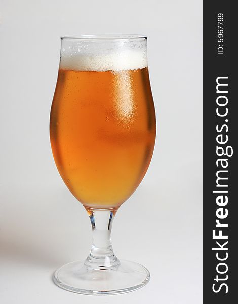 Glass of beer with water condensing on the glass. Glass of beer with water condensing on the glass