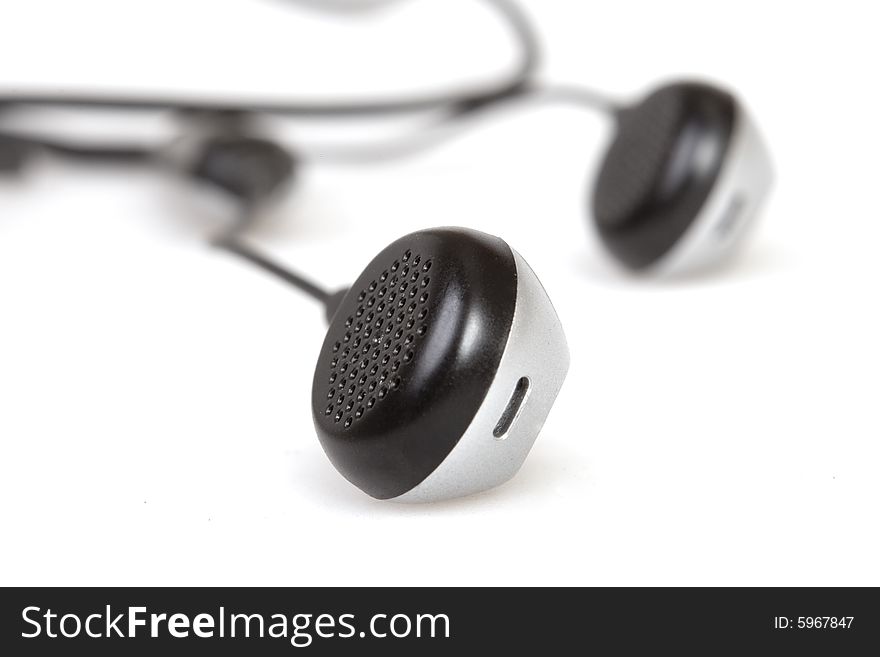 Black earphones on white ground