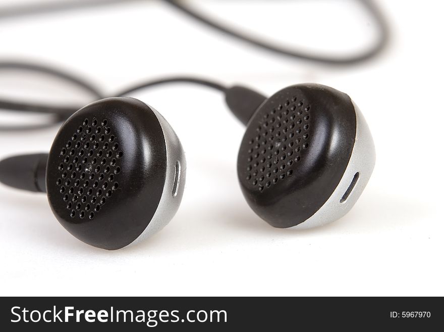 Black earphones on white ground