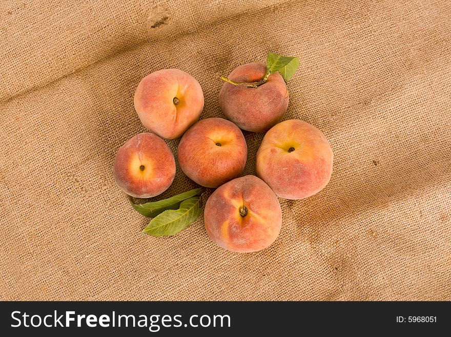 Ripe peaches on burlap texture