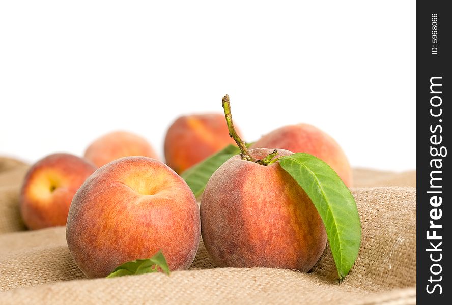 Ripe peaches on burlap texture