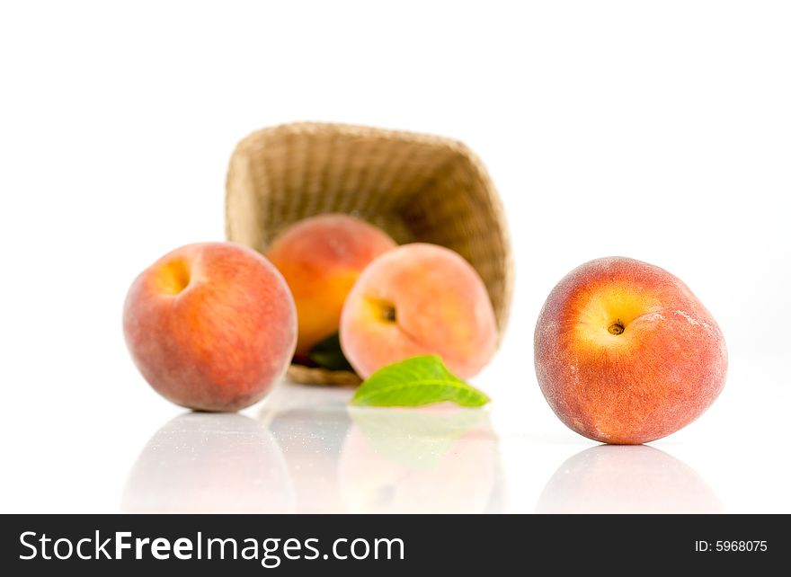 Ripe peaches falling from a basket